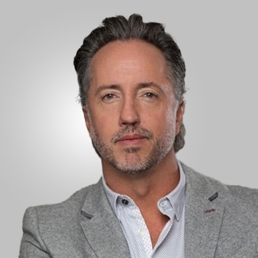 Portrait of a man with glasses wearing a gray shirt.