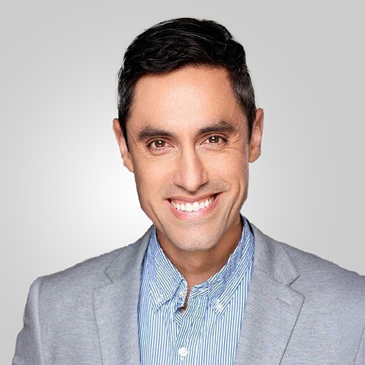 Portrait of a man with glasses wearing a gray shirt.